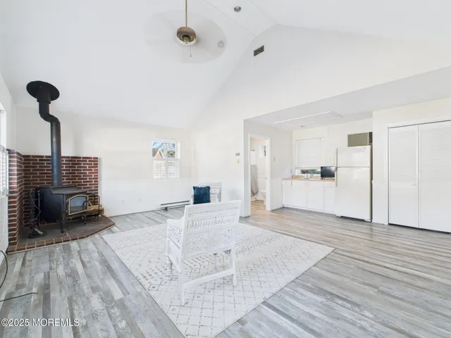 a view of kitchen and living room with wooden floor