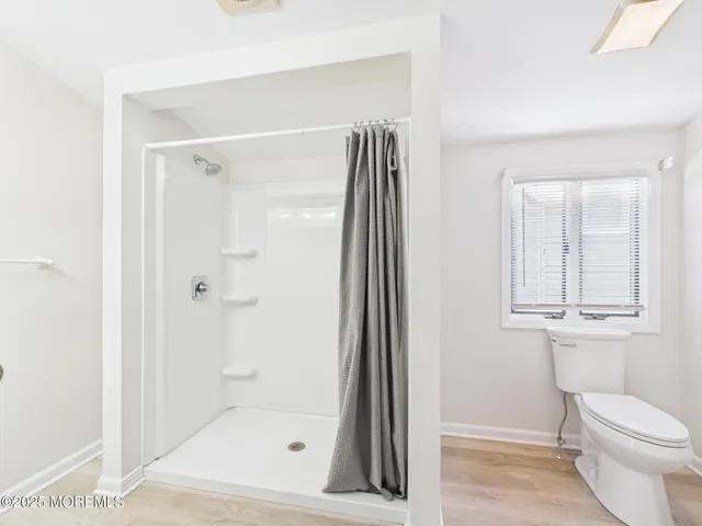a bathroom with a shower and a toilet