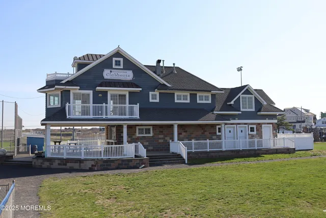 a front view of a house with a yard table and chairs