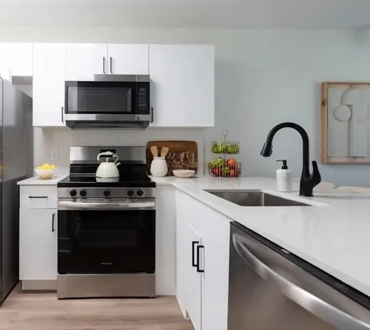 a kitchen with a sink and a stove top oven