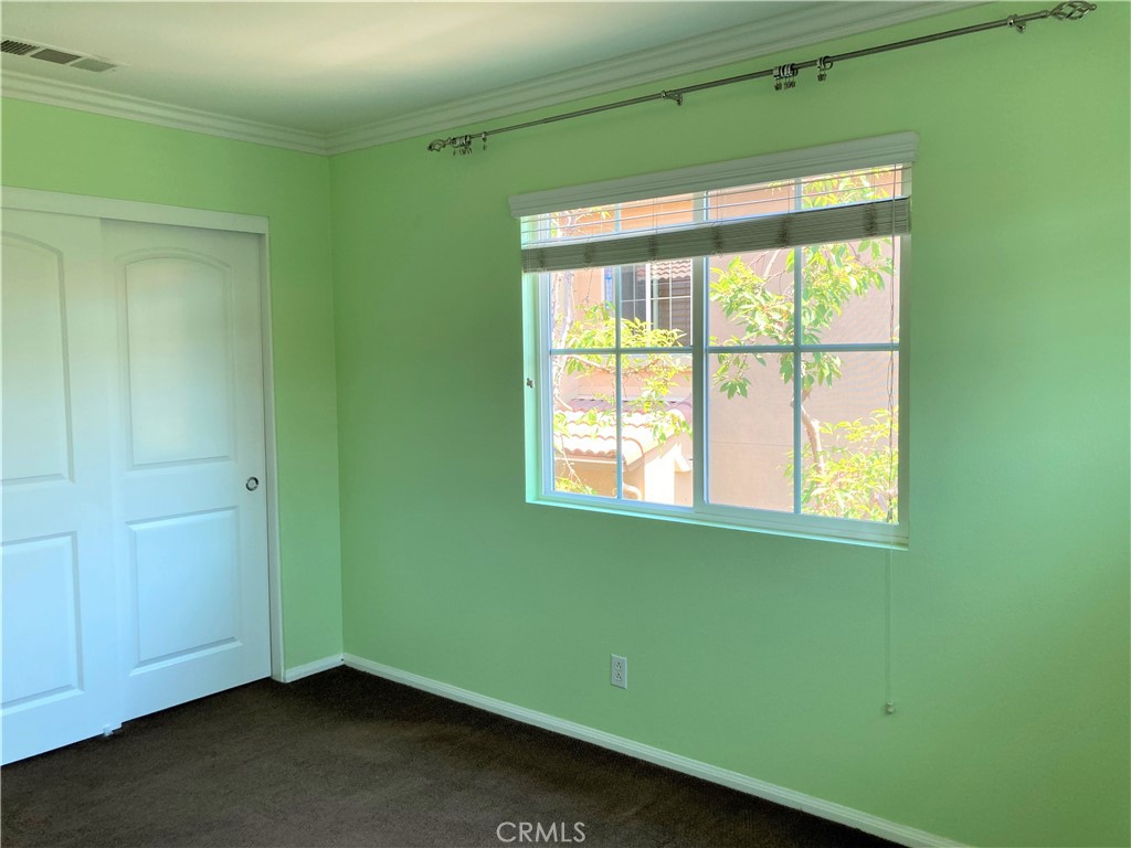 26 Opus Irvine, CA 92618 - Photo 19 of 32 an empty room with a window and a ceiling fan