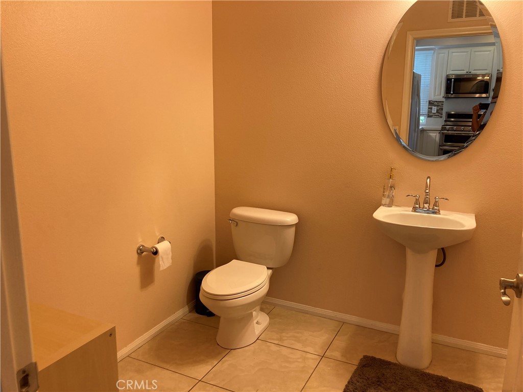 26 Opus Irvine, CA 92618 - Photo 21 of 32 a bathroom with a toilet sink and mirror