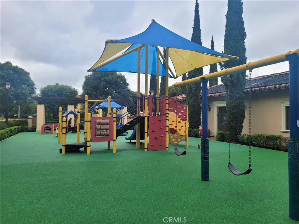 26 Opus Irvine, CA 92618 - Photo 28 of 32 a childrens park with lots of swings and slides and swimming pool
