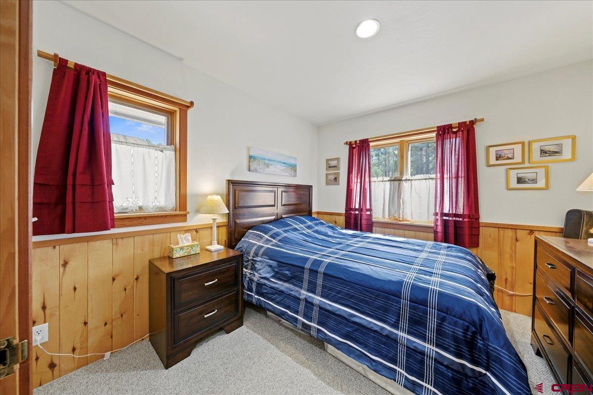 66 Blue Stem Ridgway, CO 81432 - Photo 14 of 19 a bedroom with a bed and wooden floor