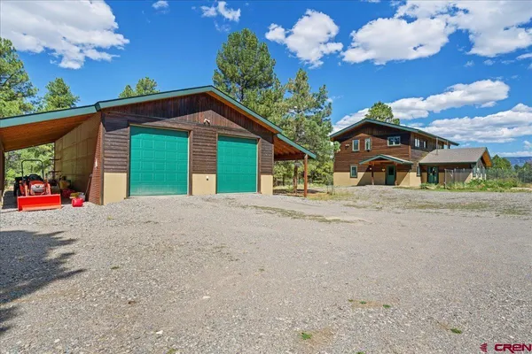 a view of a house with a yard and garage