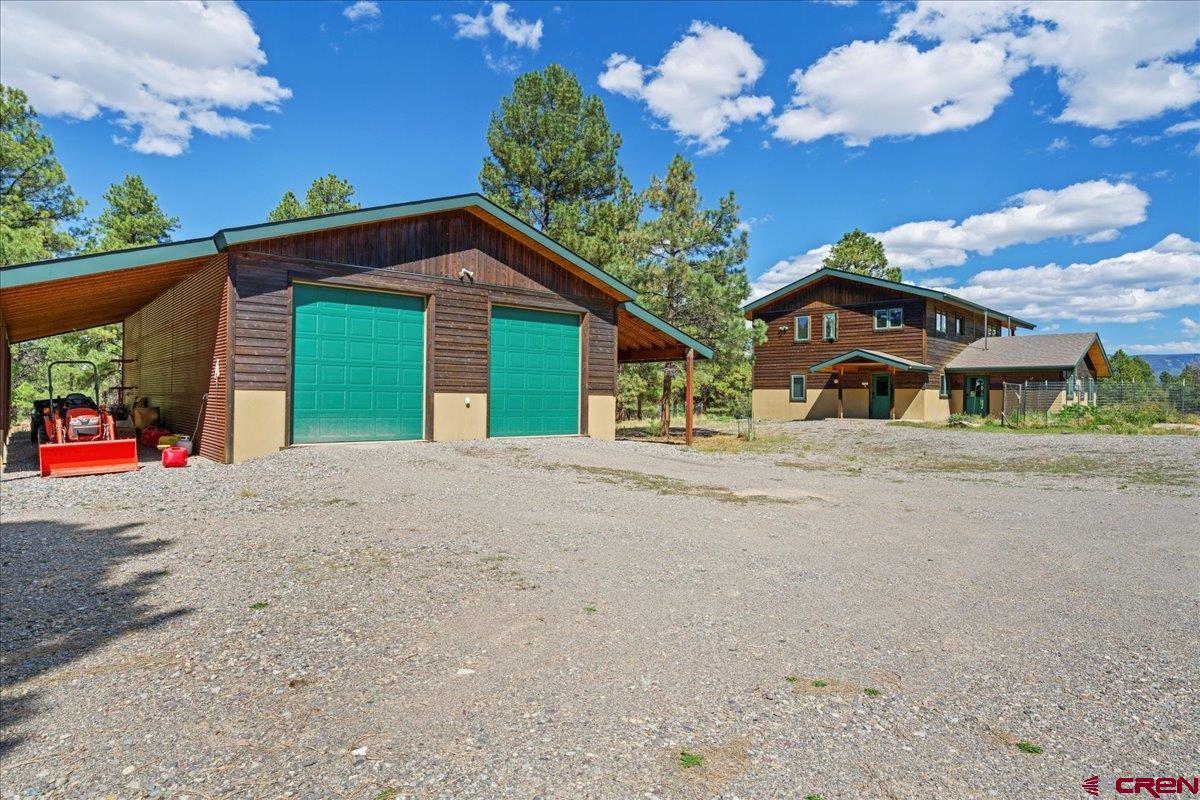 66 Blue Stem Ridgway, CO 81432 - Photo 18 of 19 a view of a house with a yard and garage