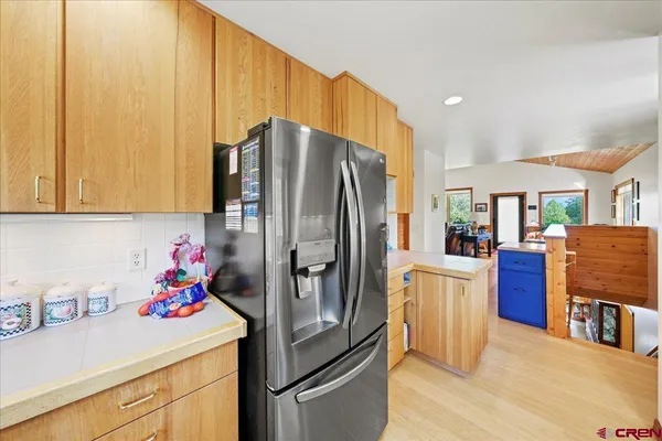 a kitchen with stainless steel appliances granite countertop a refrigerator and a stove