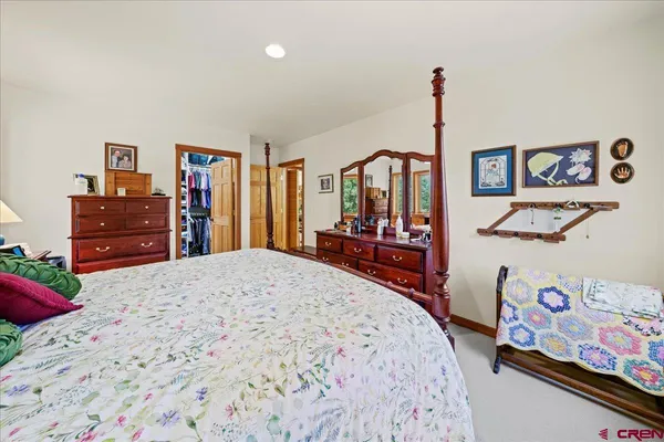 a bedroom with a bed and dresser