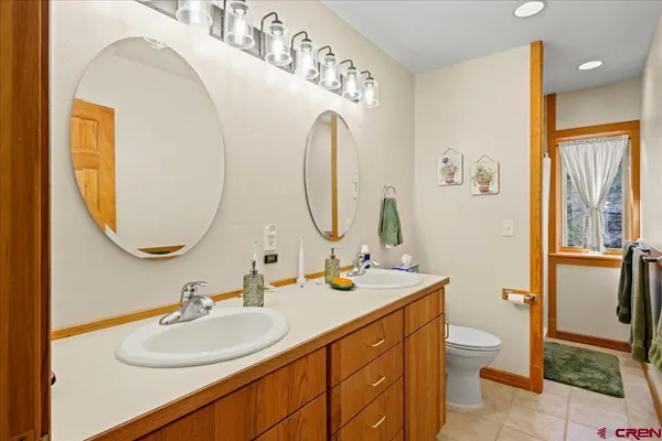 a bathroom with a toilet sink and mirror