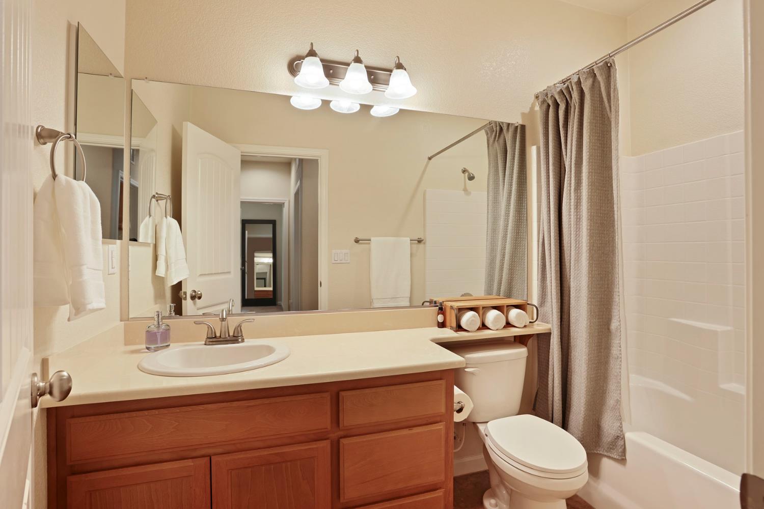 3828 Lookout Drive Modesto, CA 95355 - Photo 15 of 39 a bathroom with a sink vanity mirror and toilet