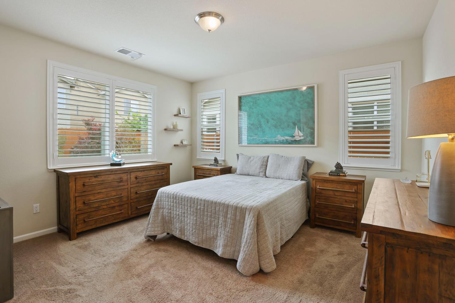 3828 Lookout Drive Modesto, CA 95355 - Photo 18 of 39 a bedroom with a bed and windows