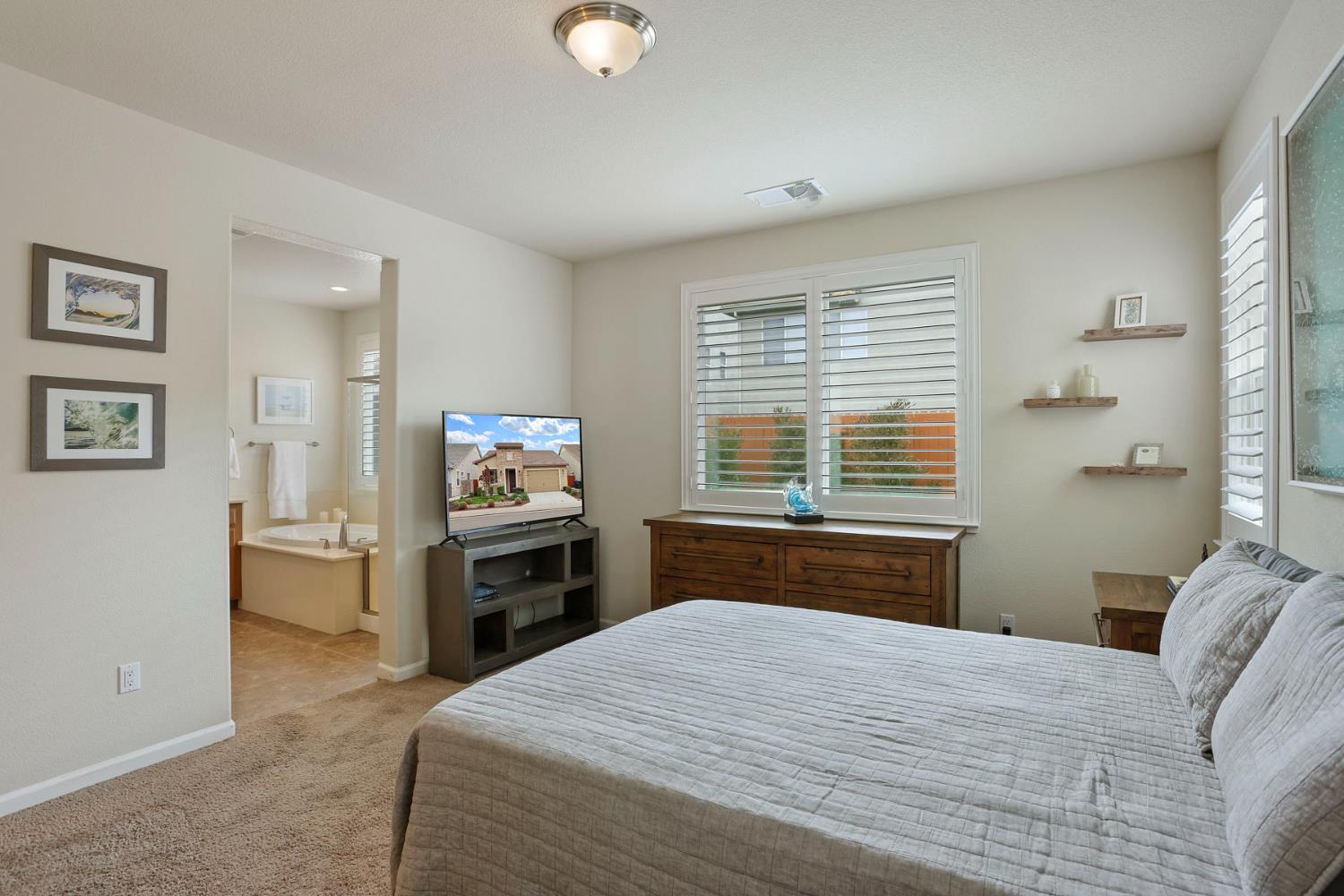 3828 Lookout Drive Modesto, CA 95355 - Photo 19 of 39 a bedroom with a bed and wooden floor