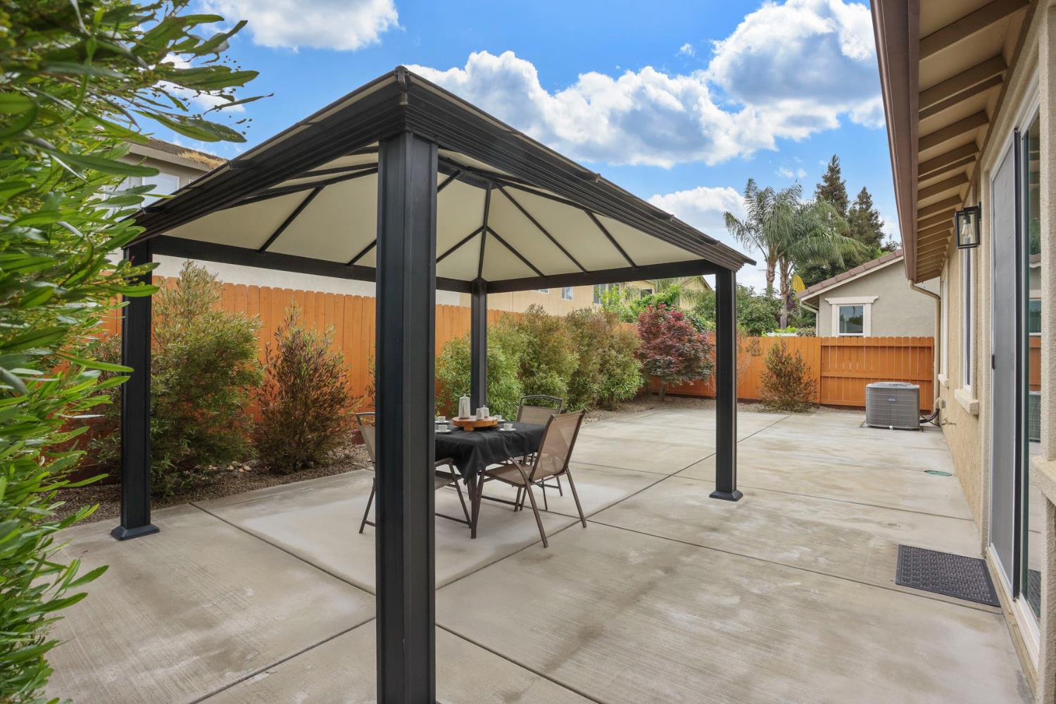 3828 Lookout Drive Modesto, CA 95355 - Photo 22 of 39 a backyard of a house with table and chairs