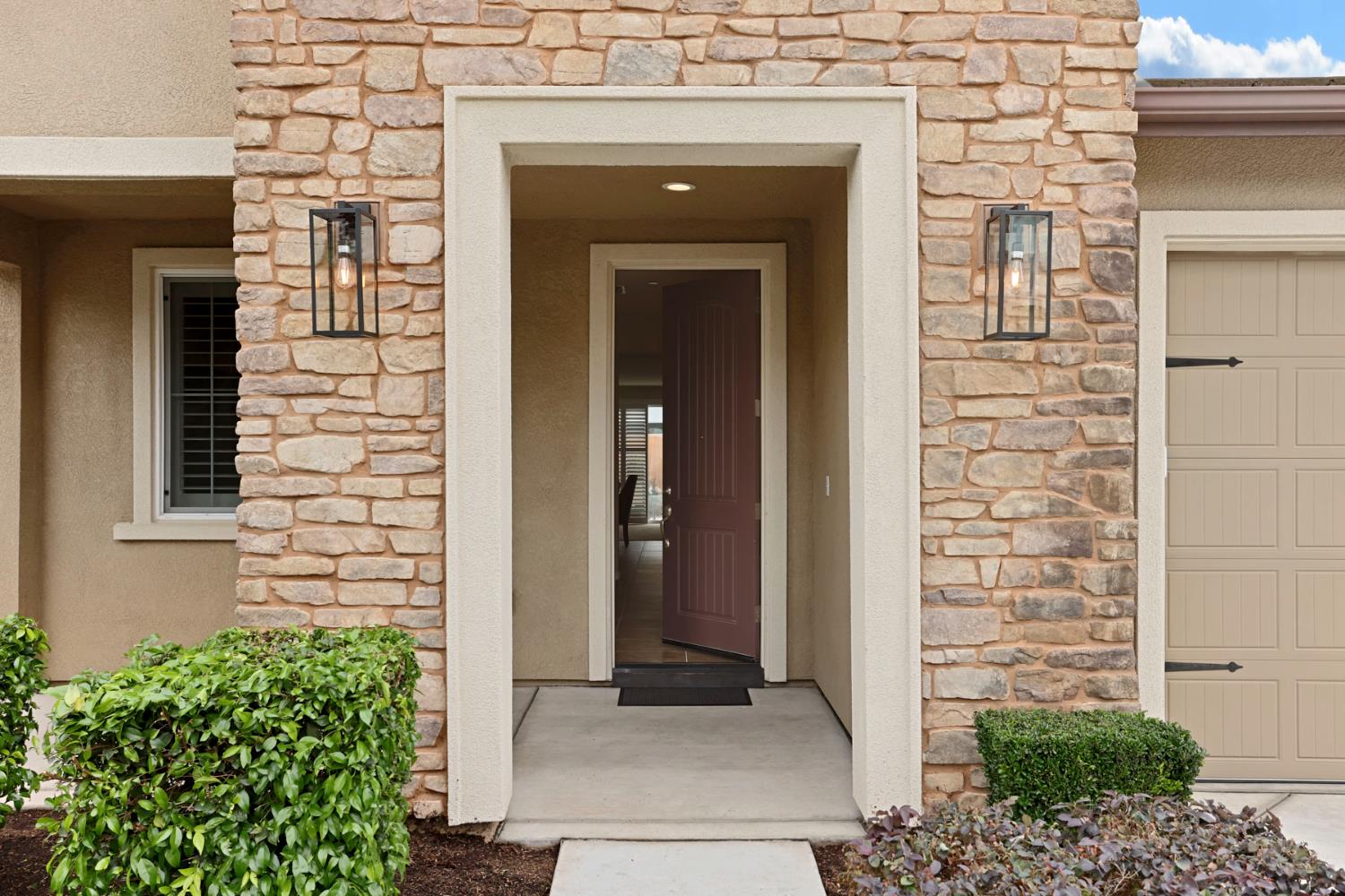 3828 Lookout Drive Modesto, CA 95355 - Photo 3 of 39 front view of a brick house with a large door