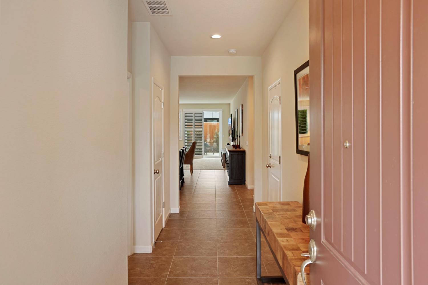 3828 Lookout Drive Modesto, CA 95355 - Photo 4 of 39 a view of a hallway with a furniture and a mirror
