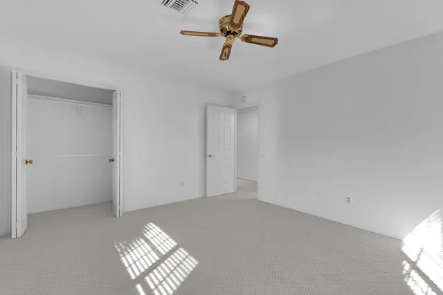a view of a kitchen with a sink and a refrigerator