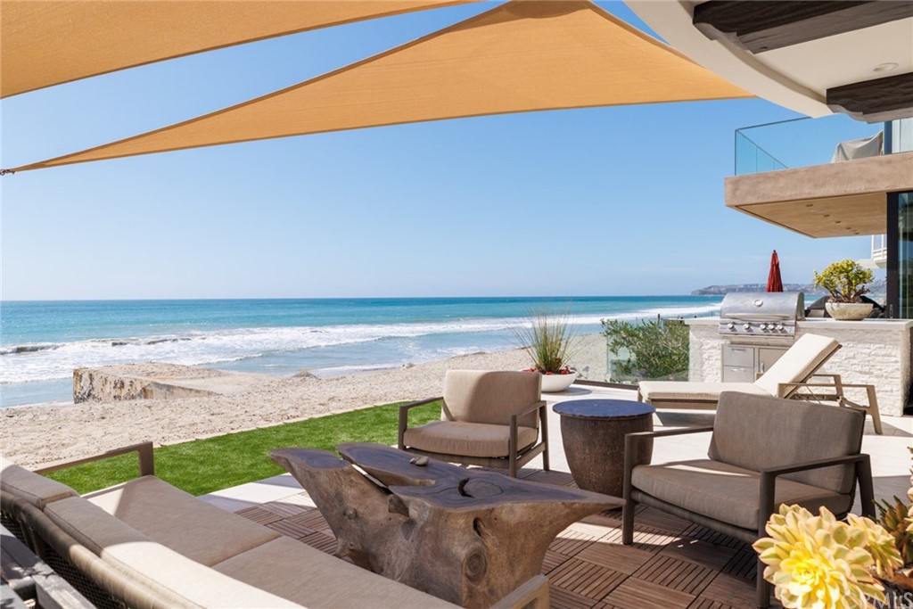 35271 Beach Road Dana Point, CA 92624 - Photo 13 of 61 a view of a patio with lawn chairs under an umbrella