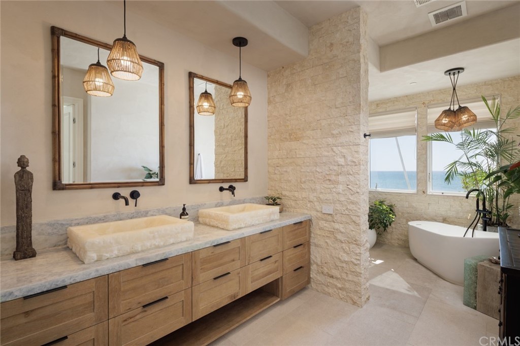 35271 Beach Road Dana Point, CA 92624 - Photo 27 of 61 a bathroom with double vanity sink a two mirror a lamp and a window
