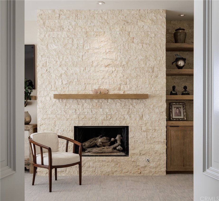 35271 Beach Road Dana Point, CA 92624 - Photo 31 of 61 a fireplace with a table and chairs