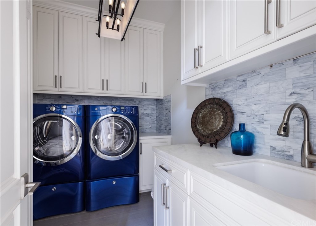 35271 Beach Road Dana Point, CA 92624 - Photo 52 of 61 a kitchen with kitchen island a stove and a refrigerator with white cabinets