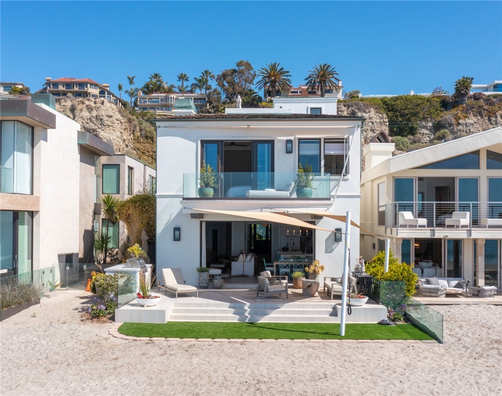 35271 Beach Road Dana Point, CA 92624 - Photo 56 of 61 a view of a white house with a swimming pool and a yard