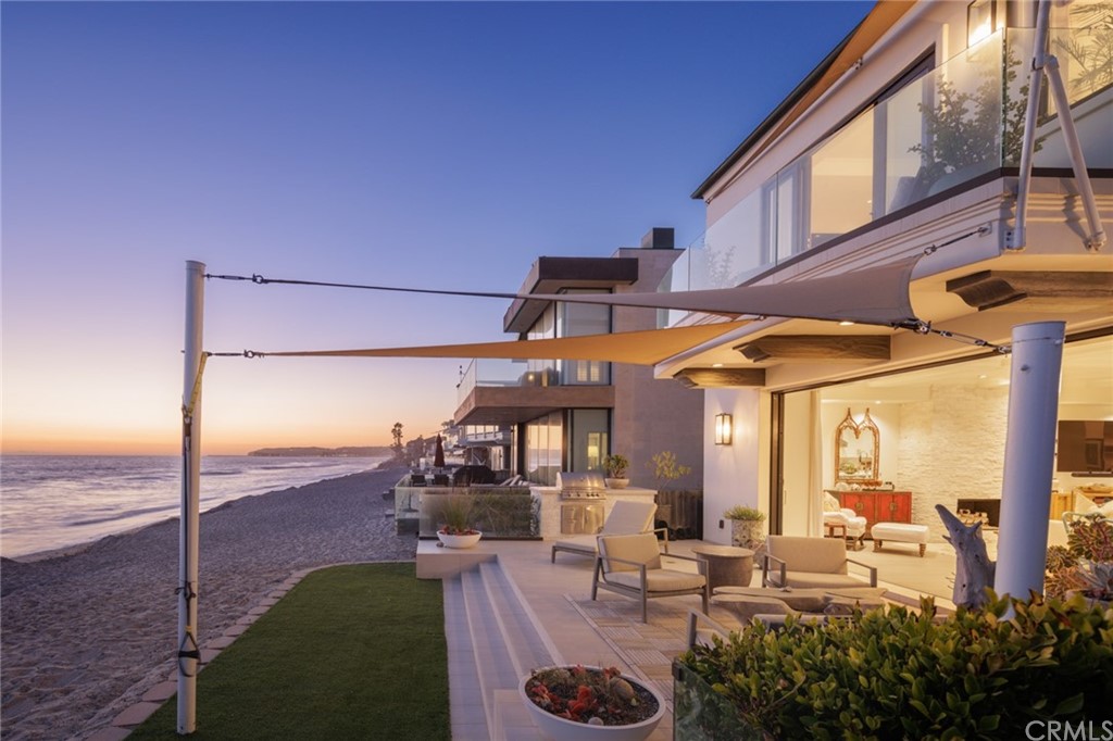 35271 Beach Road Dana Point, CA 92624 - Photo 10 of 61 a view of a patio with couches table and chairs under an umbrella with a fire pit
