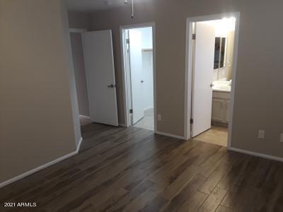 4957 Casper Road Mesa, AZ 85205 - Photo 21 of 24 an empty room with wooden floor and closet