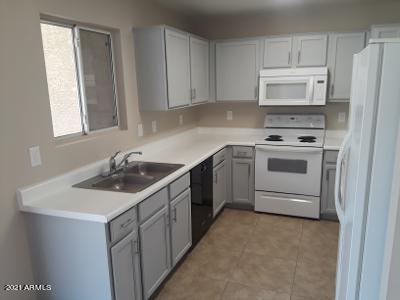 4957 Casper Road Mesa, AZ 85205 - Photo 4 of 24 a kitchen with a sink stove and microwave