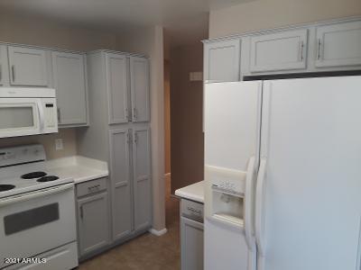 4957 Casper Road Mesa, AZ 85205 - Photo 6 of 24 a kitchen with white cabinets and white appliances