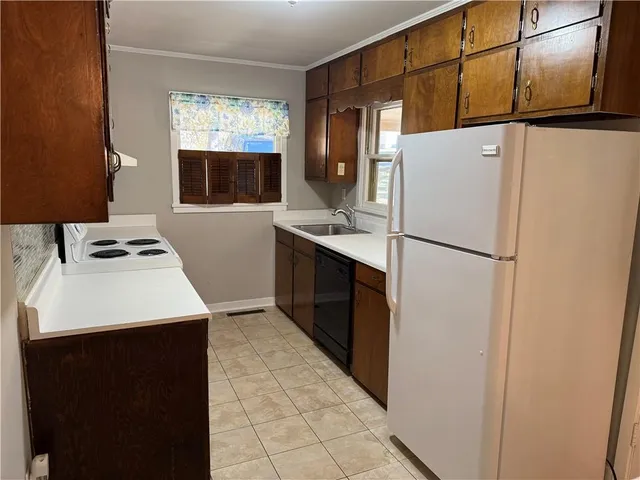 a kitchen with stainless steel appliances a refrigerator sink and microwave