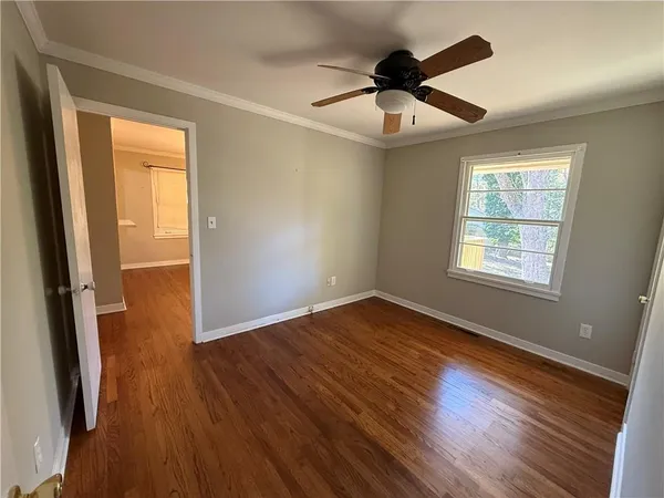 wooden floor in an empty room with a window