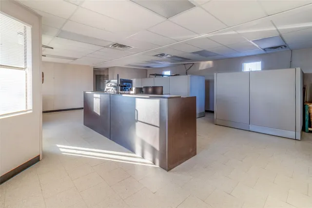 a view of a refrigerator in kitchen and a window