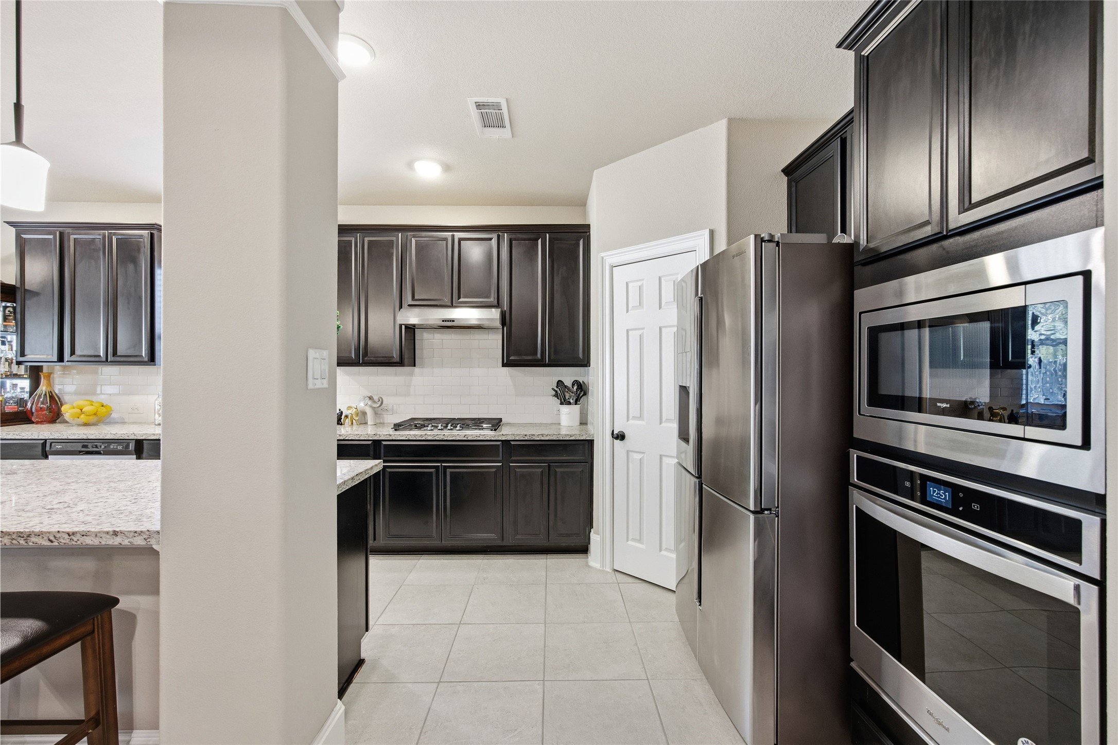 3313 Flagstone Drive Manvel, TX 77578 - Photo 12 of 39 a kitchen with stainless steel appliances granite countertop a refrigerator and a stove top oven