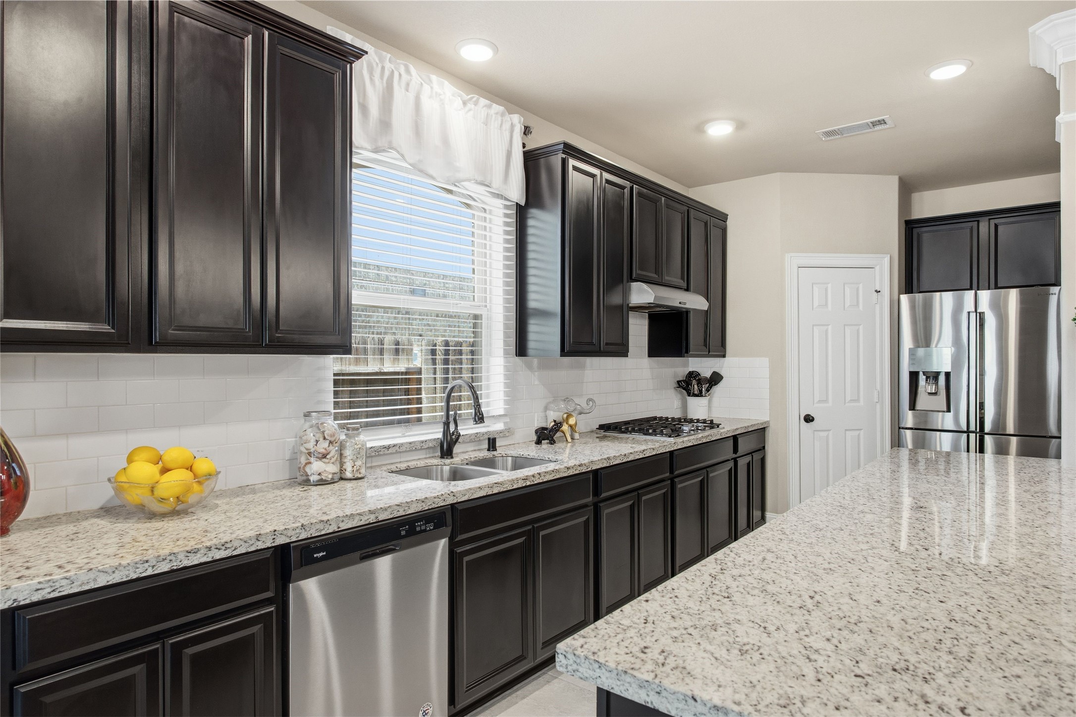 3313 Flagstone Drive Manvel, TX 77578 - Photo 14 of 39 a kitchen with stainless steel appliances granite countertop a sink stove and refrigerator