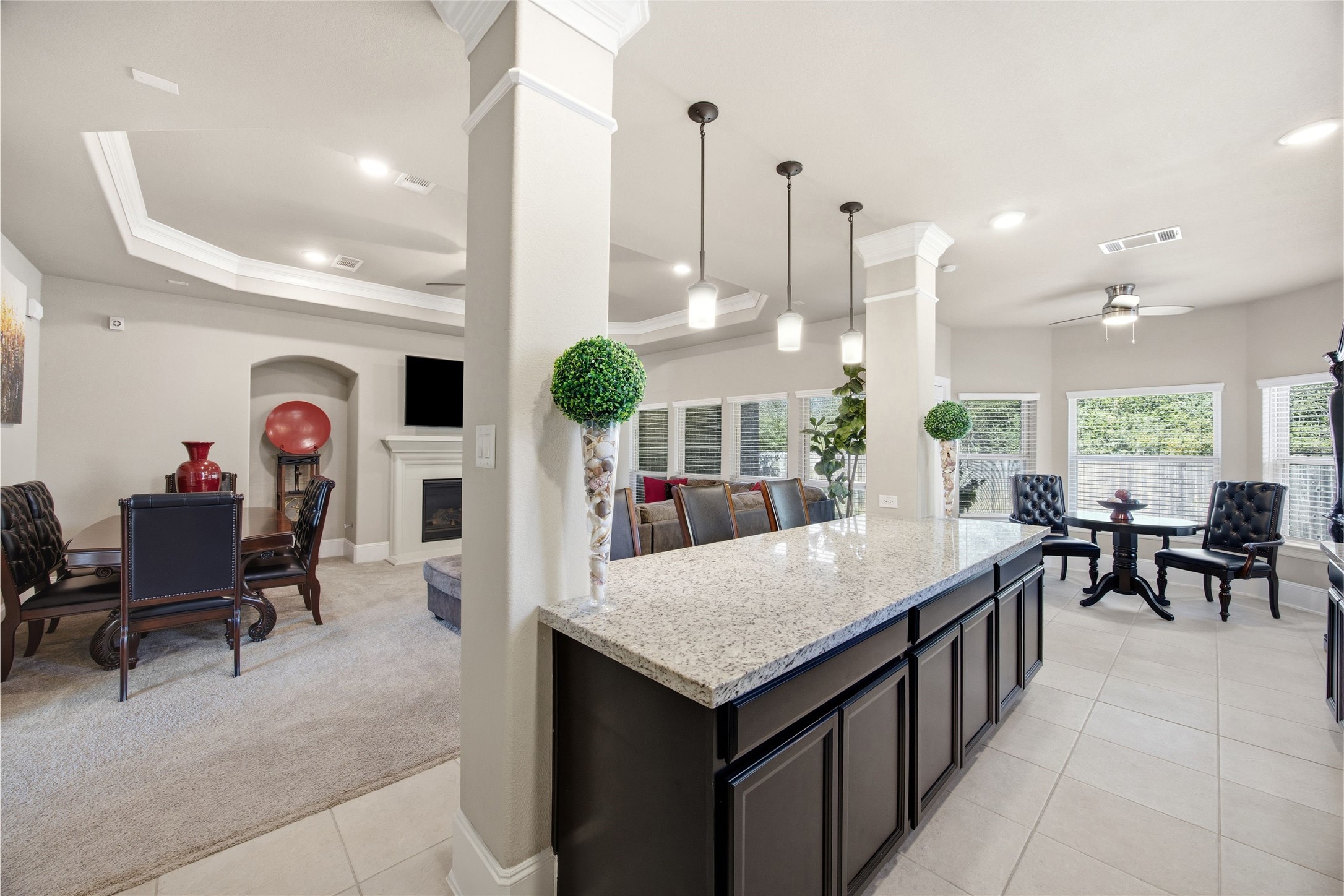 3313 Flagstone Drive Manvel, TX 77578 - Photo 15 of 39 a dining hall with stainless steel appliances kitchen island granite countertop a table chairs and a view of living room
