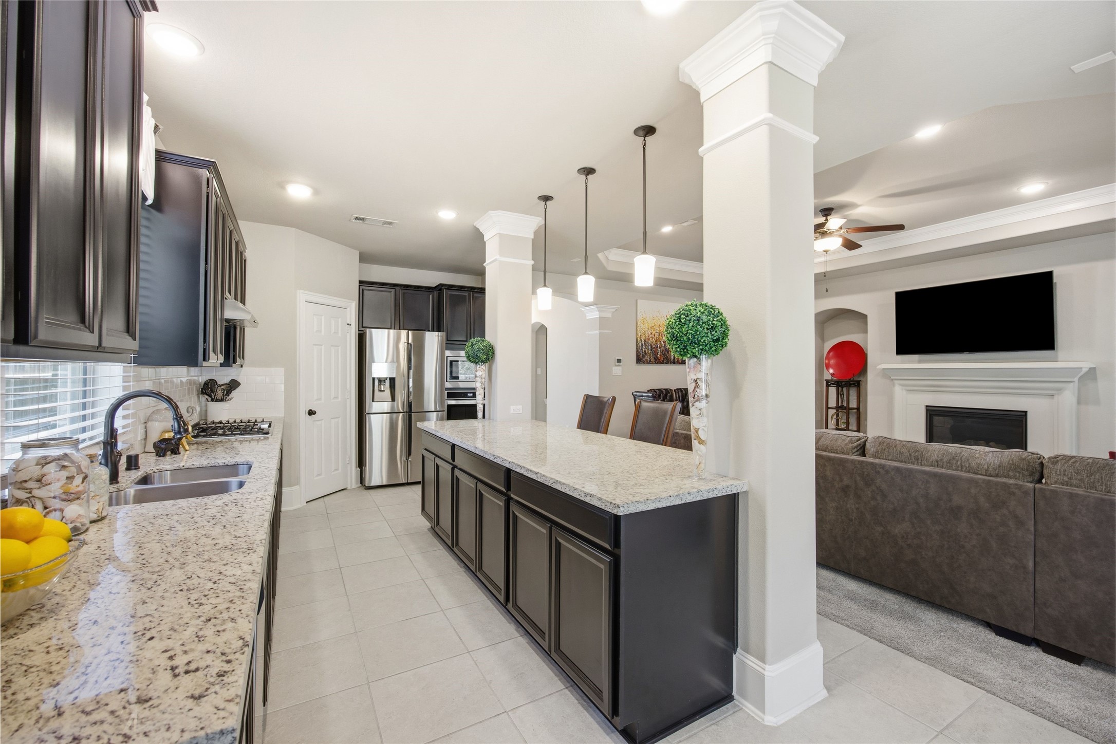 3313 Flagstone Drive Manvel, TX 77578 - Photo 16 of 39 a kitchen with stainless steel appliances a sink a stove and a flat screen tv