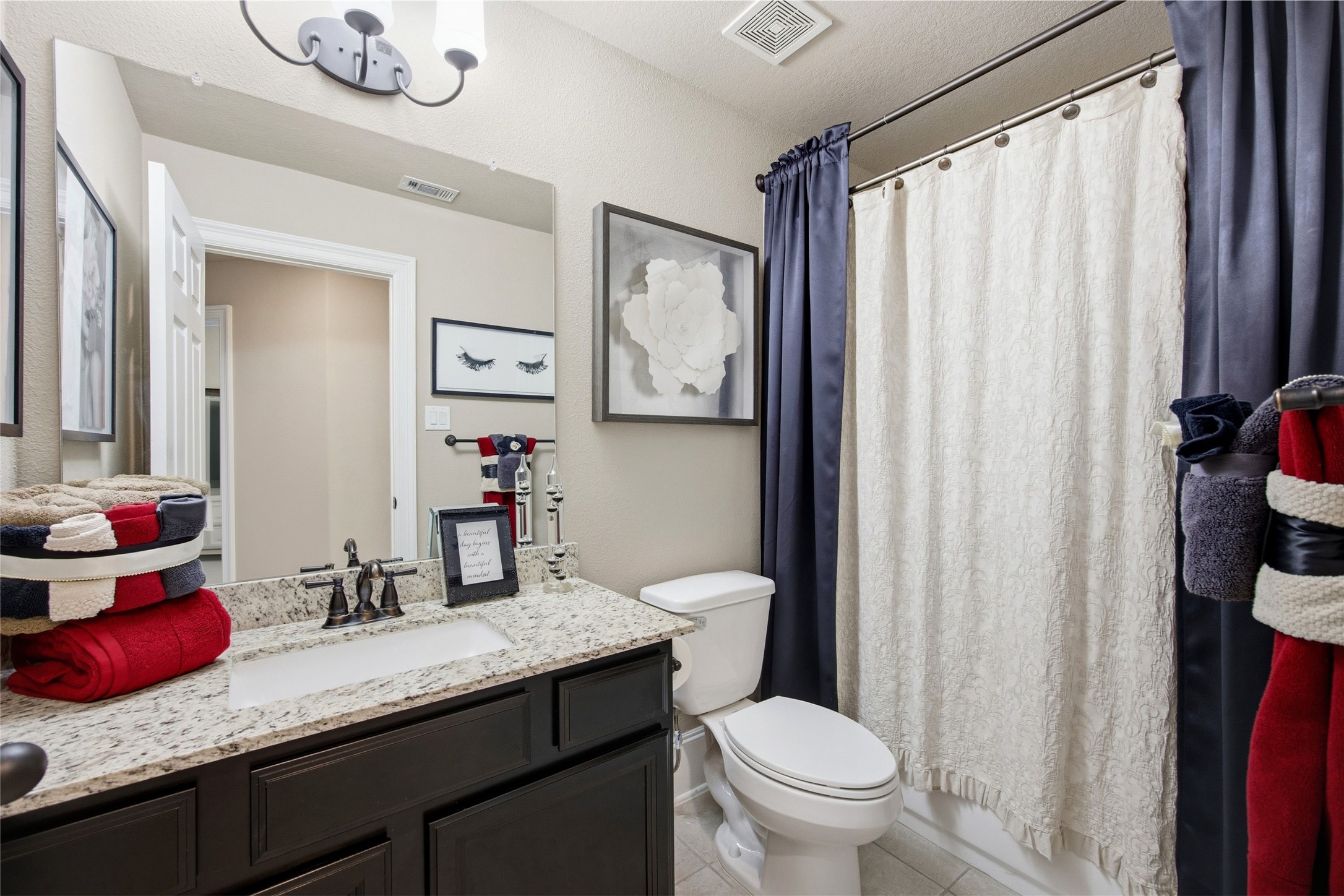 3313 Flagstone Drive Manvel, TX 77578 - Photo 27 of 39 a bathroom with a granite countertop sink a toilet and a mirror