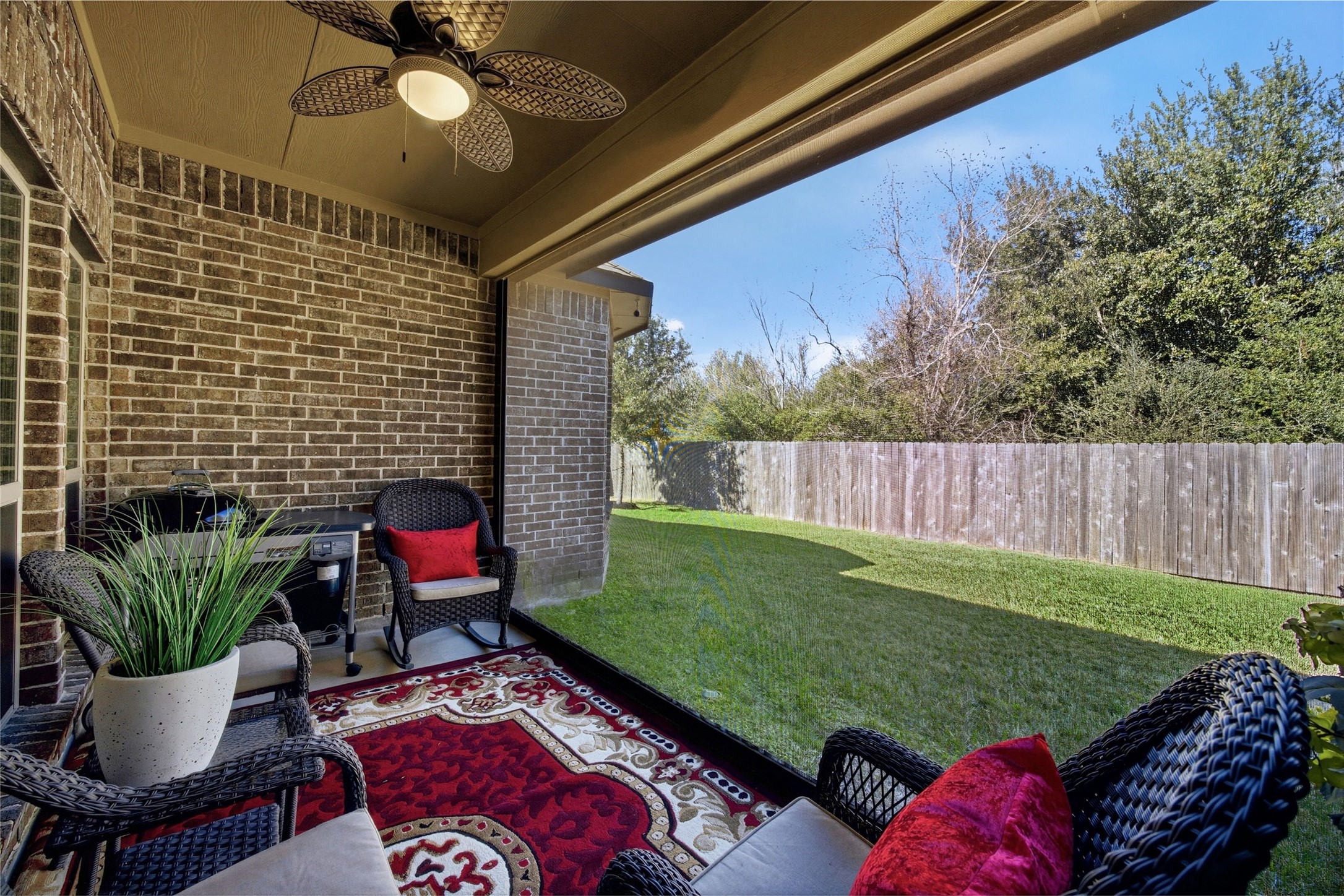 3313 Flagstone Drive Manvel, TX 77578 - Photo 28 of 39 a view of a backyard with table and chairs potted plants and a fire pit