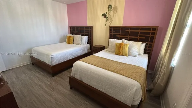 a bedroom with double bed and a window