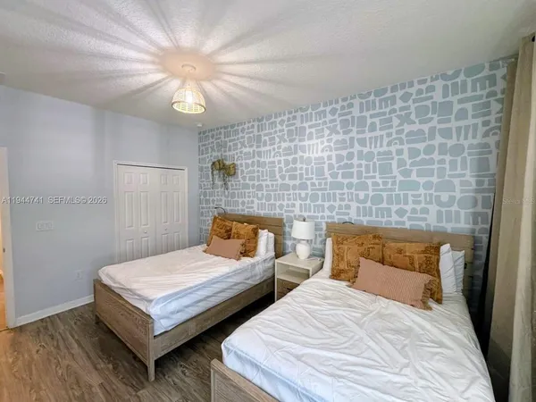 a bedroom with a bed and a chandelier