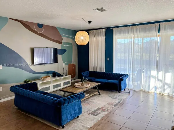 a living room with furniture and a large window