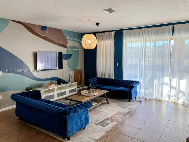 a living room with furniture and a large window