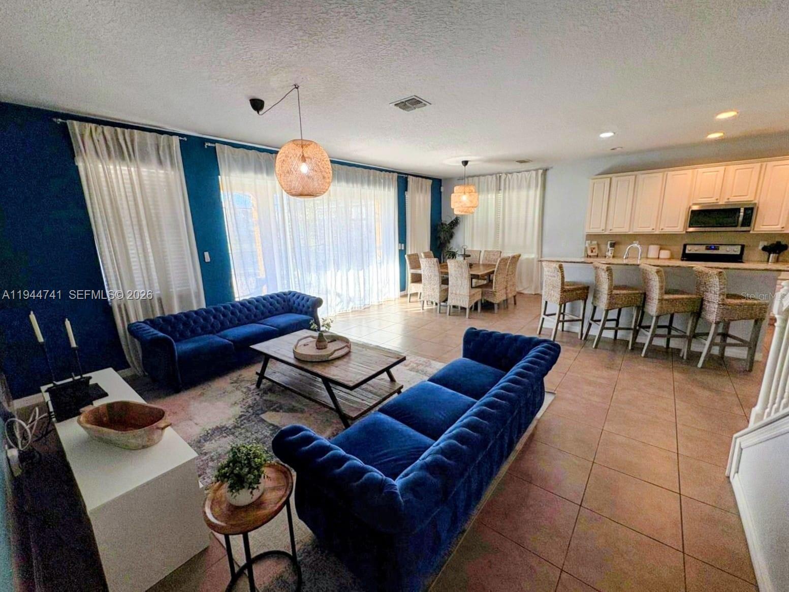 4445 Shiva Loop, Unit 4445 Kissimmee, FL 34746 - Photo 20 of 31 a living room with furniture kitchen view and a large window