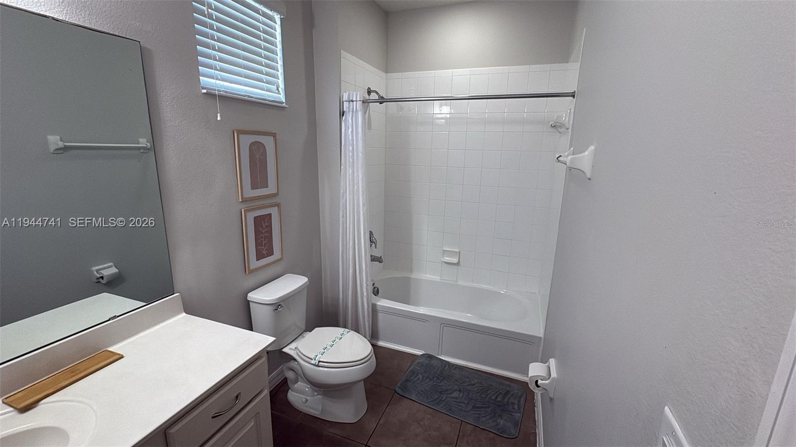 4445 Shiva Loop, Unit 4445 Kissimmee, FL 34746 - Photo 21 of 31 a bathroom with a toilet and a shower