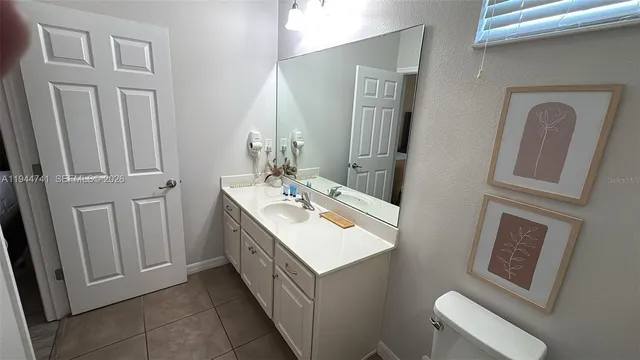 a bathroom with a sink a toilet and mirror