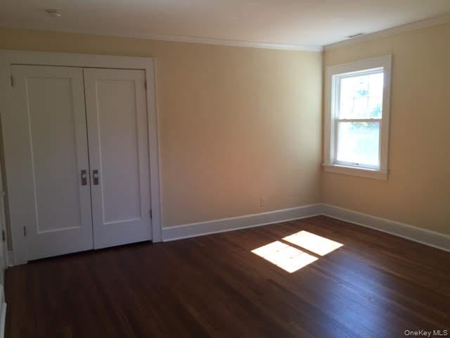 471 Webster Avenue New Rochelle, NY 10801 - Photo 11 of 22 Unfurnished room featuring dark wood finished floors, ornamental molding, and a smoke detector