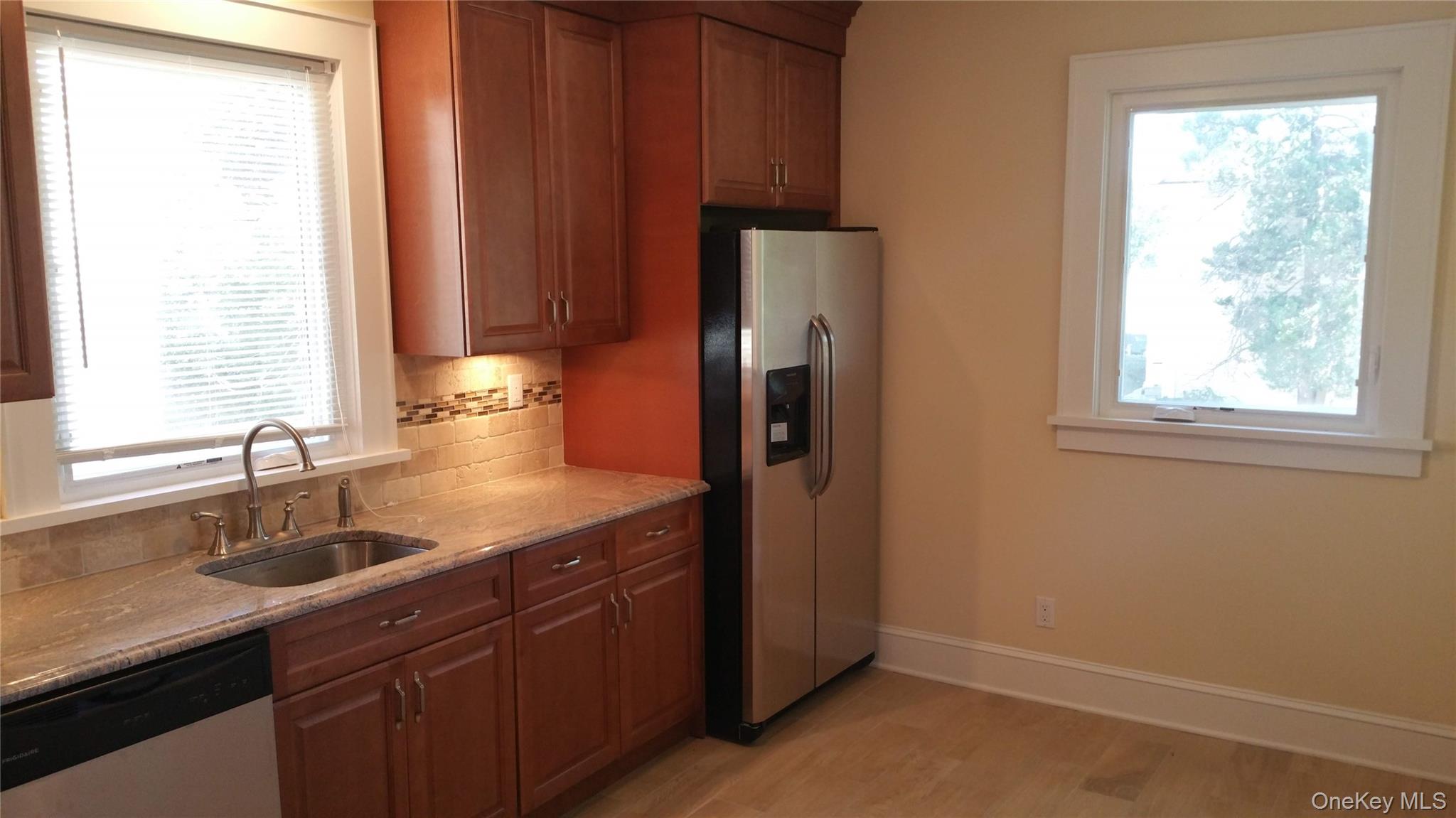 471 Webster Avenue New Rochelle, NY 10801 - Photo 3 of 22 Kitchen featuring appliances with stainless steel finishes, tasteful backsplash, plenty of natural light, and light floors