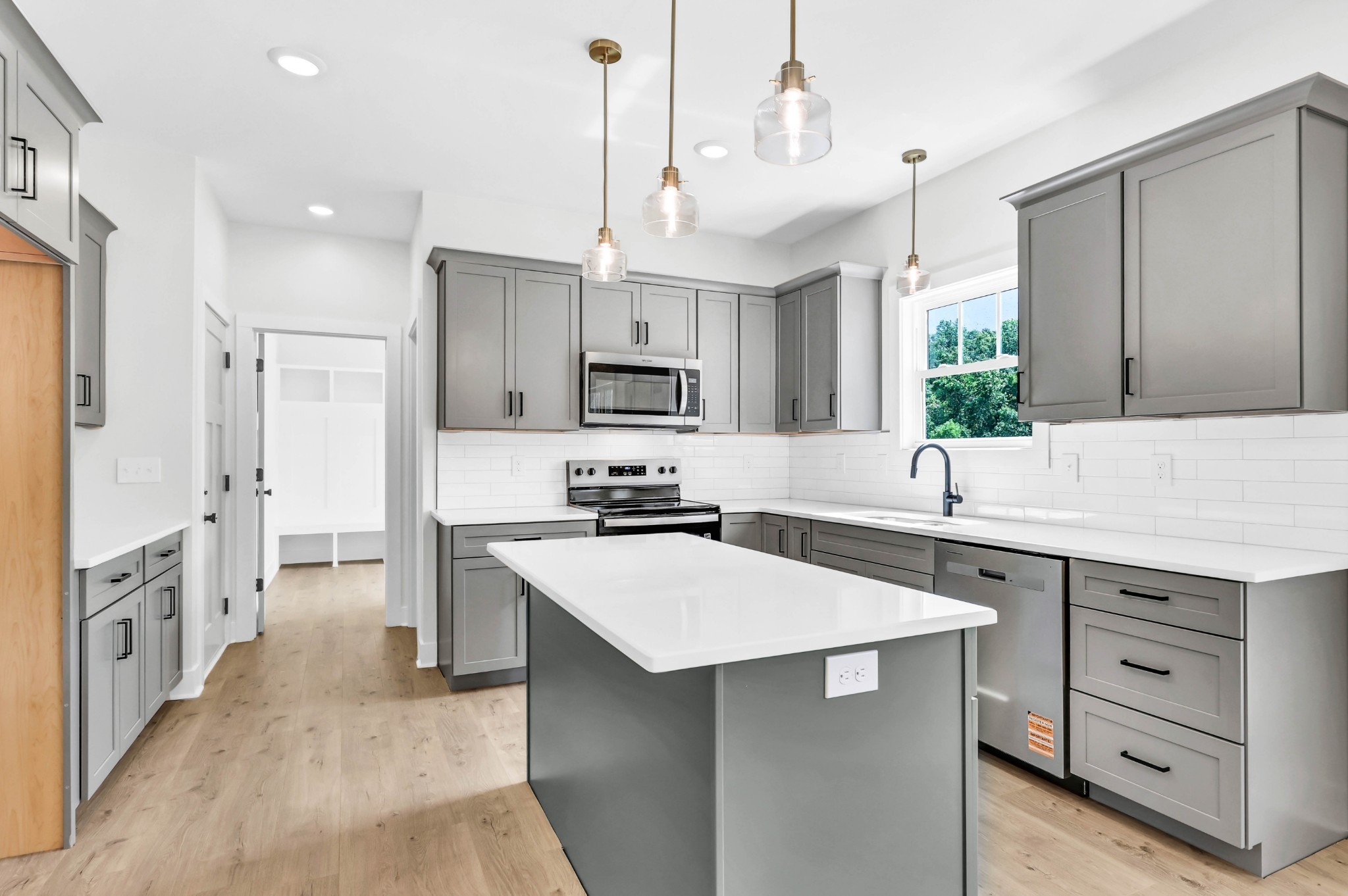 5590 Chambers Road Cumberland Furnace, TN 37051 - Photo 11 of 47 a kitchen with white cabinets and stainless steel appliances