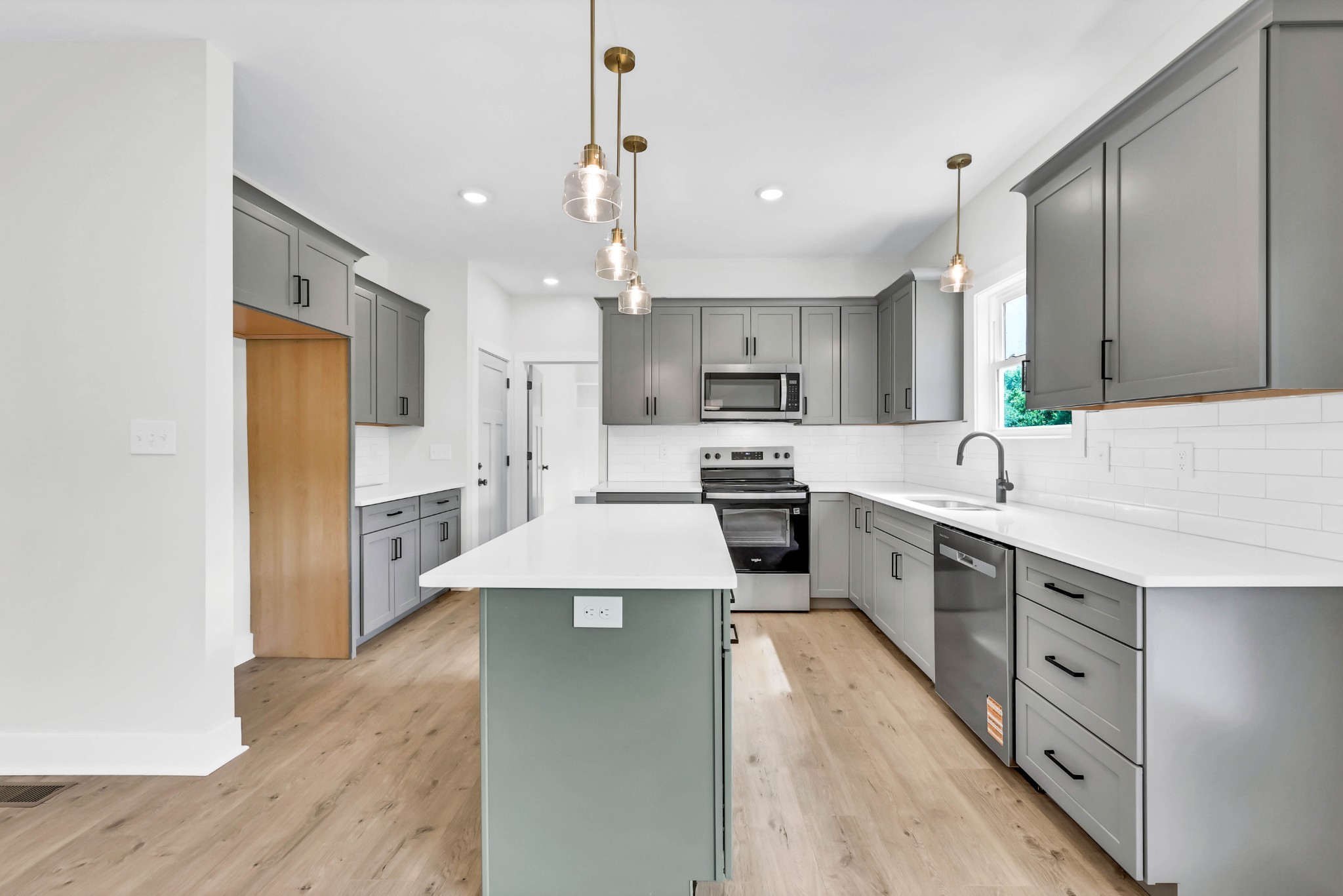 5590 Chambers Road Cumberland Furnace, TN 37051 - Photo 13 of 47 a large kitchen with stainless steel appliances kitchen island a sink stove and refrigerator
