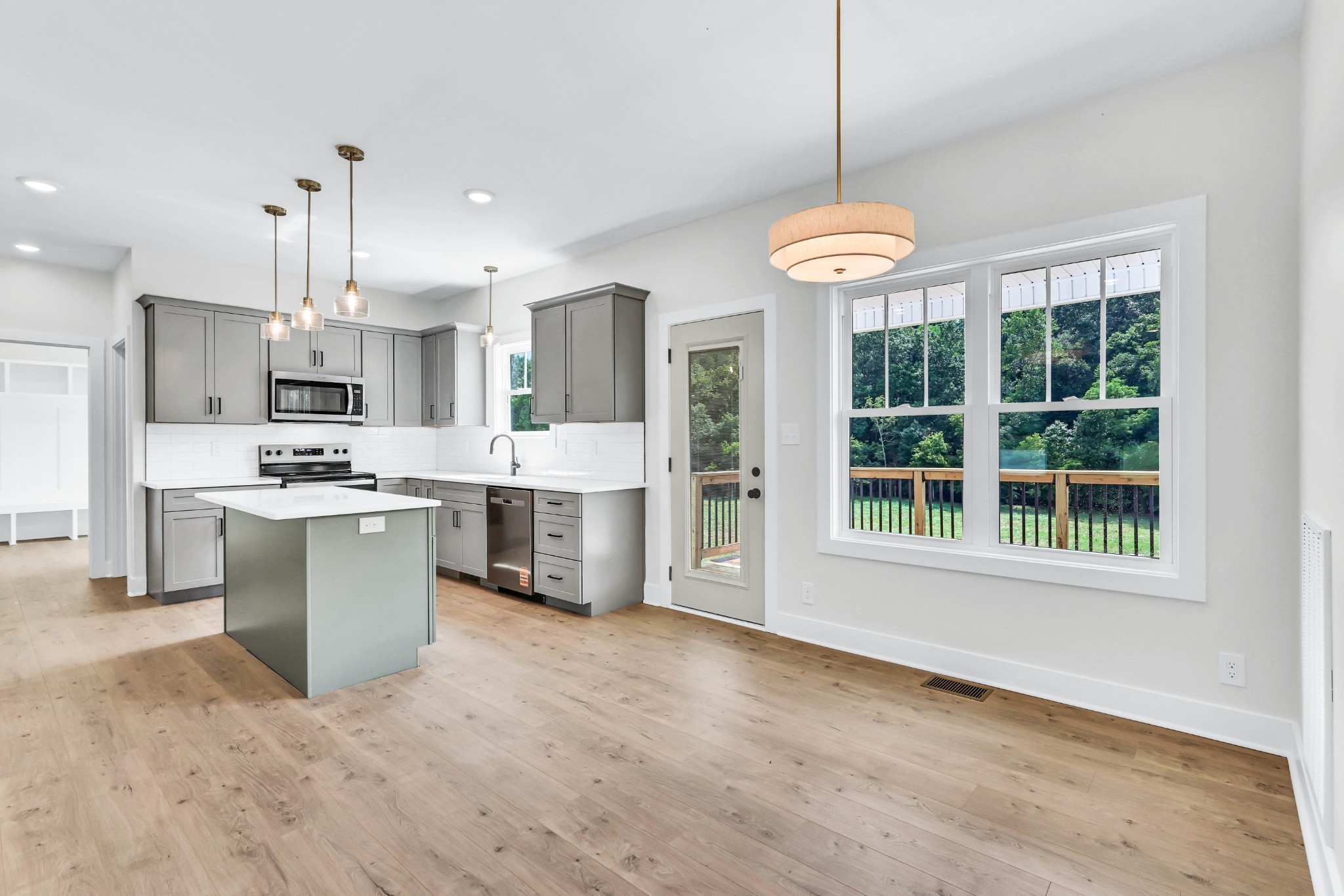 5590 Chambers Road Cumberland Furnace, TN 37051 - Photo 10 of 47 a kitchen with stainless steel appliances granite countertop a stove a sink dishwasher a refrigerator and a dining table with wooden floor